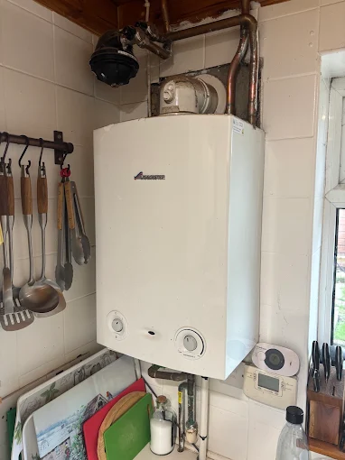 Gas boiler being serviced in a domestic kitchen