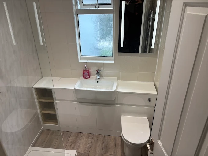 White gloss fitted bathroom furniture with concealed cistern WC